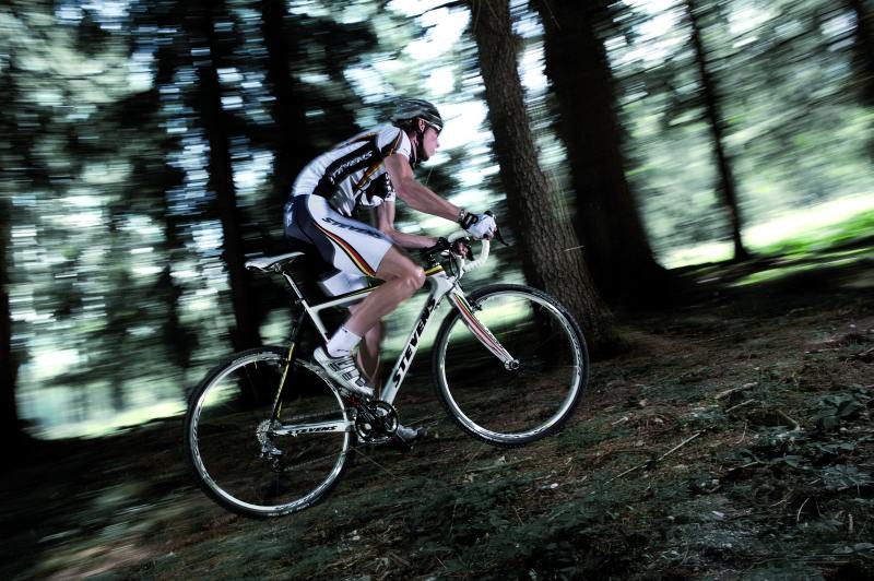 Ein Cycle-Cross-Athlet erklimmt eine Steigung im Wald